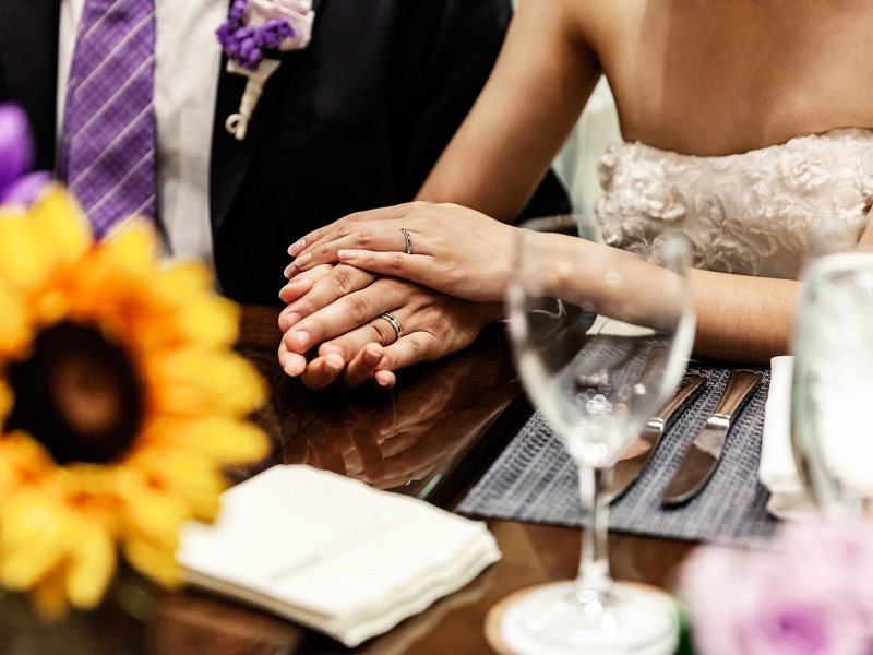 bride and groom holding hands on wedding day of two Christian singles