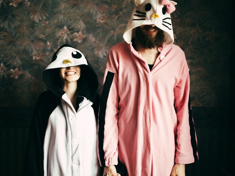couple wearing animal onesies and laughing at nicknames