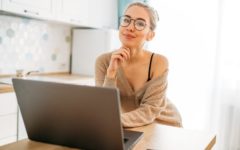 attractive young woman in front of laptop using a tinder profile template