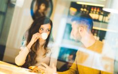 Attractive couple in a cafe coming up with things to talk about on a first date
