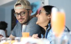 A couple laughing in a cafe with the guy giving off signs he's into you