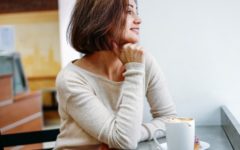 Attractive 40 year old woman drinking coffee in cafe