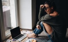 attractive woman laughing in front of laptop speaking with man who knows how to start a conversation with a girl online