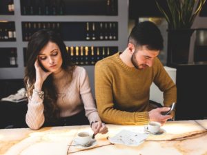 unhappy couple in a cafe discussing how to break up with someone you live with