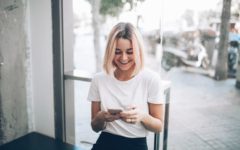 woman laughing after getting flirty text messages for her