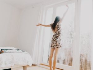 girl stretching in bedroom inspired by moving on quotes