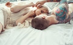 Couple lying on bed discussing intimacy issues