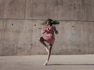 beautiful woman dancing in front of all saying yes to am I attractive