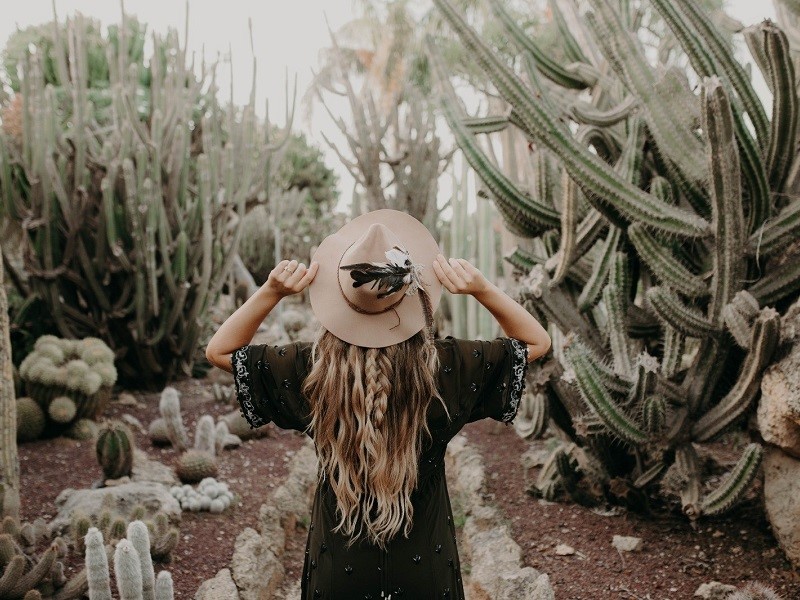 woman standing in cactus garden practicing self care after breakup