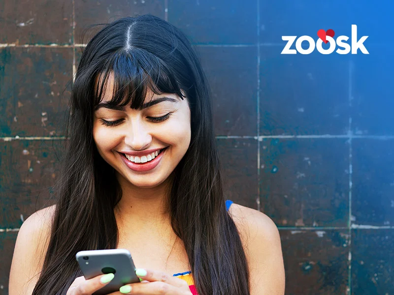 attractive woman scrolling on mobile using Zoosk search