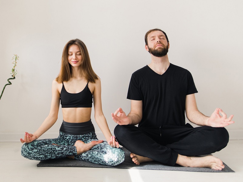 happy couple doing yoga thinking of day date ideas