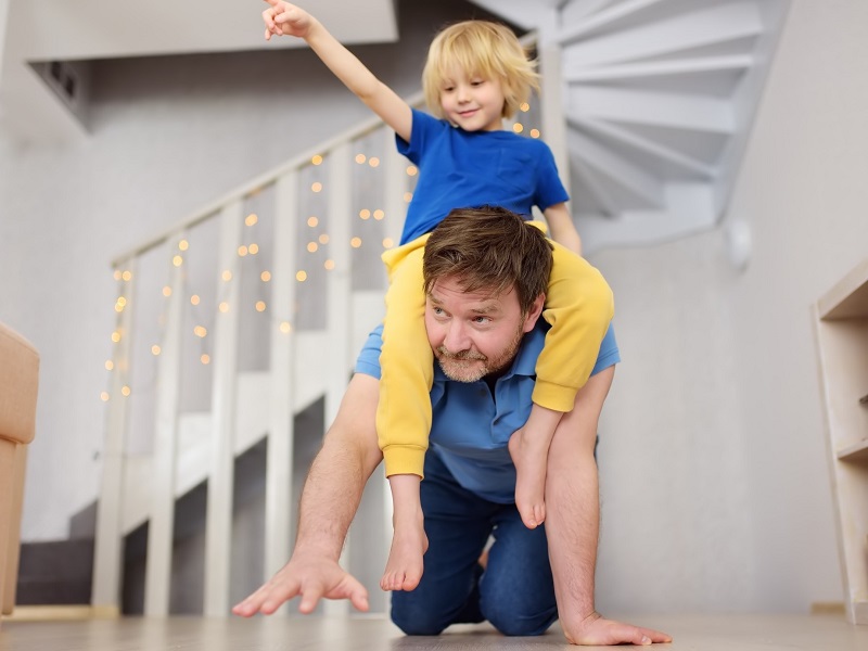 man playing with his son showing what it's like dating a guy with kids