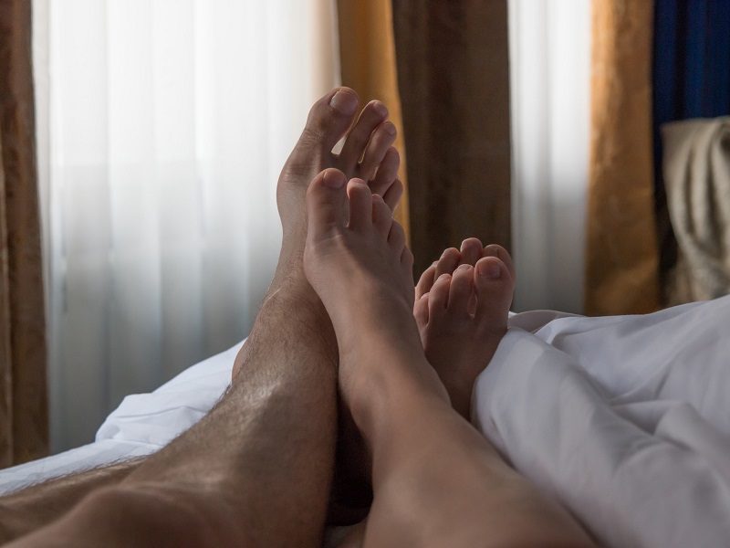couple lying in bed facing a sex life crisis together