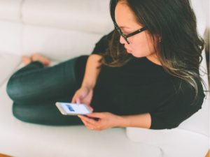 woman on her mobile at home following the online dating rules
