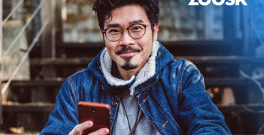 attractive man using his mobile for Zoosk sign up