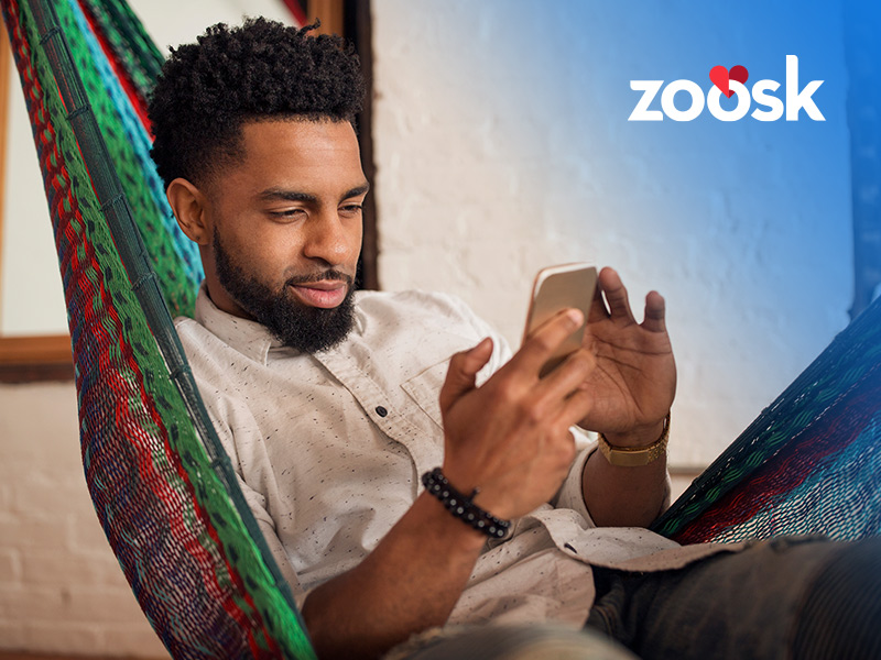 Attractive man using Zoosk online on his mobile