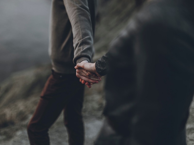 man and woman holding hands after listening to relationship advice for couples