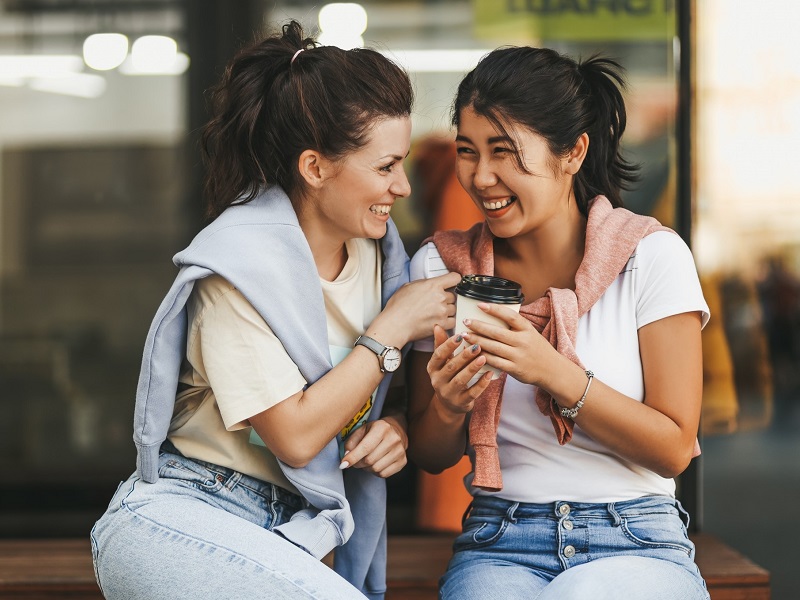 two attractive women laughing and enjoying queer dating