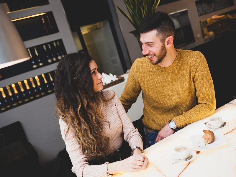 couple sitting in cafe discussing questions to ask a girl you just met