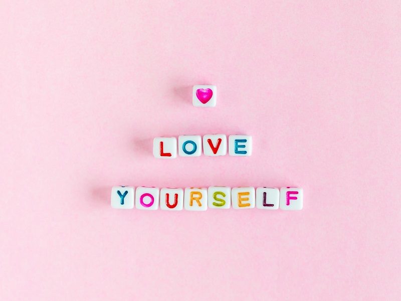 love yourself written out with colorful candy