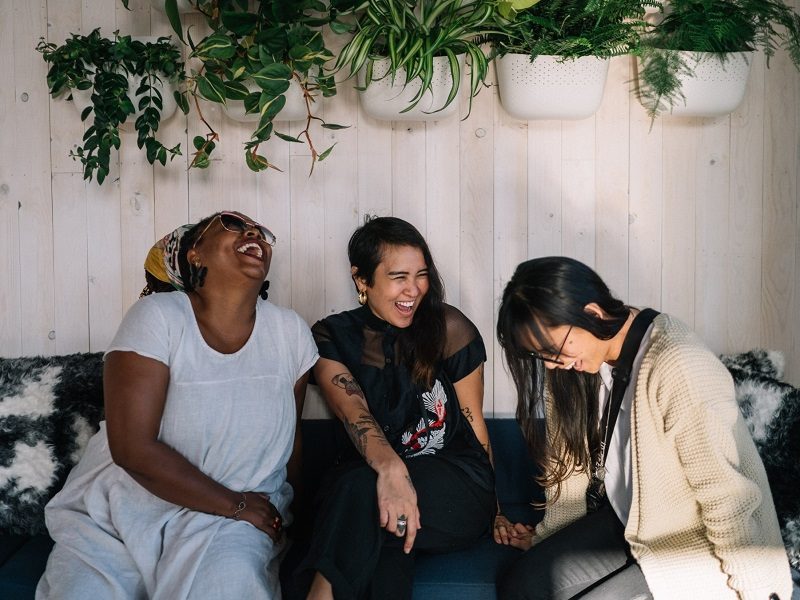 group of diverse millennial women laughing together