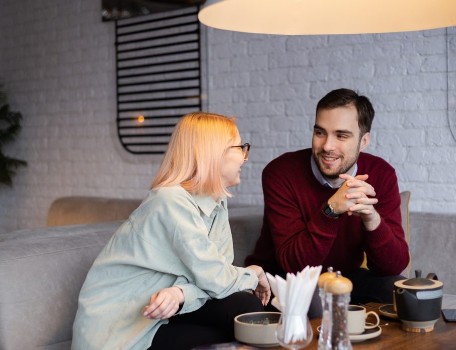 attractive couple in a café on a date laughing and keeping conversation going