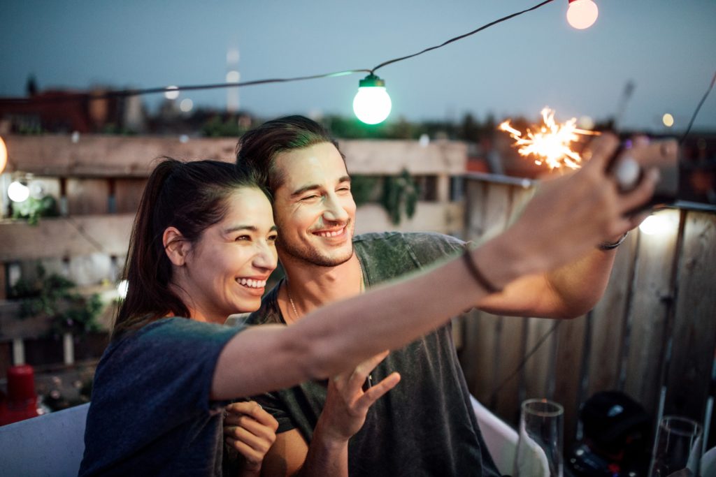 beautiful young couple at a rooftop bar in Charlotte on a date