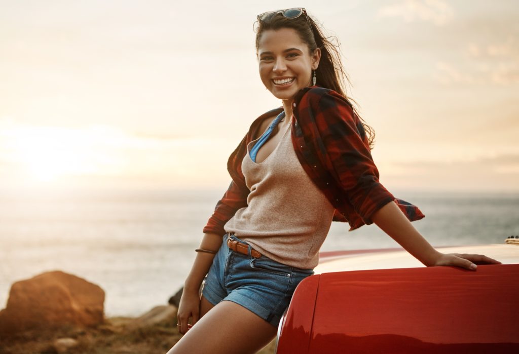 Attractive single woman laughing at the coast in Hawaii