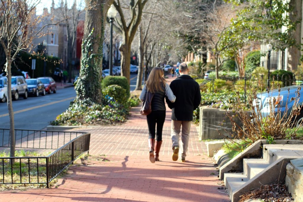 happy couple walking down the street in Washington DC arm in arm