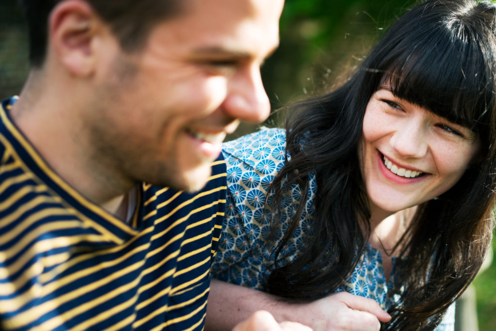 Woman and man laughing together during a date.
