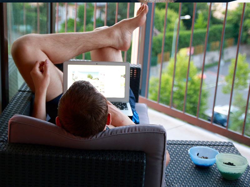 A man creating the perfect online dating profile while relaxing.