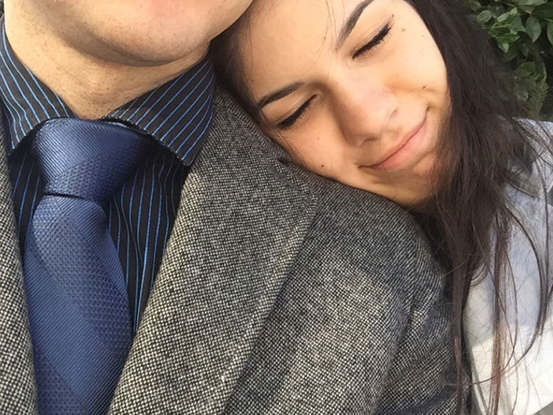 A girl resting her head on her guy friend's shoulder because he is so in the friend zone.