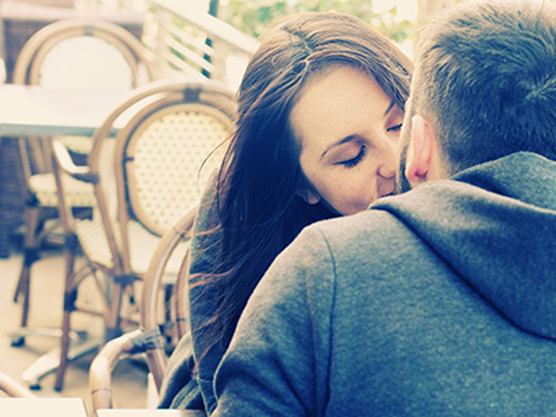 A couple kissing.
