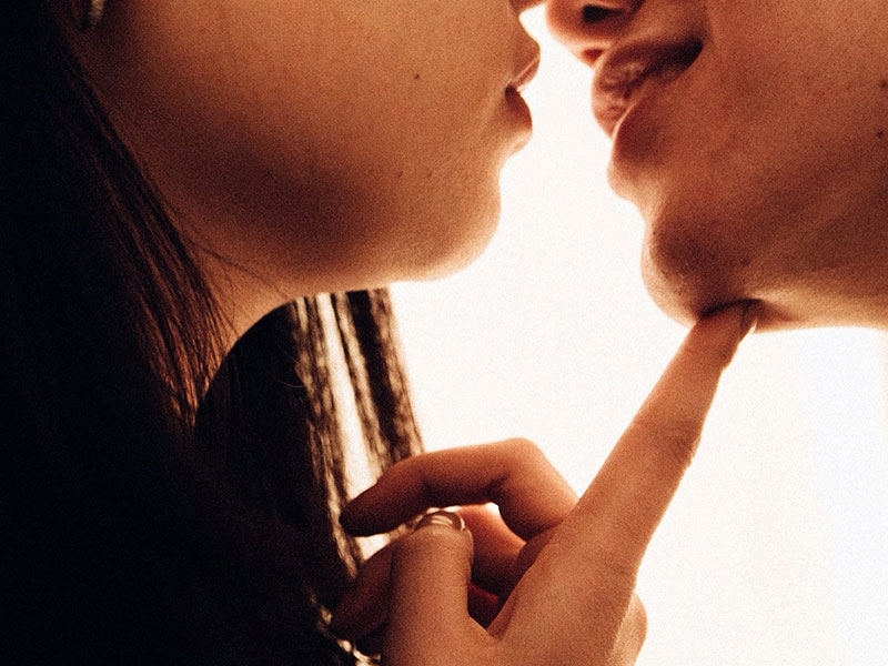 A couple having relationship problems about to kiss.