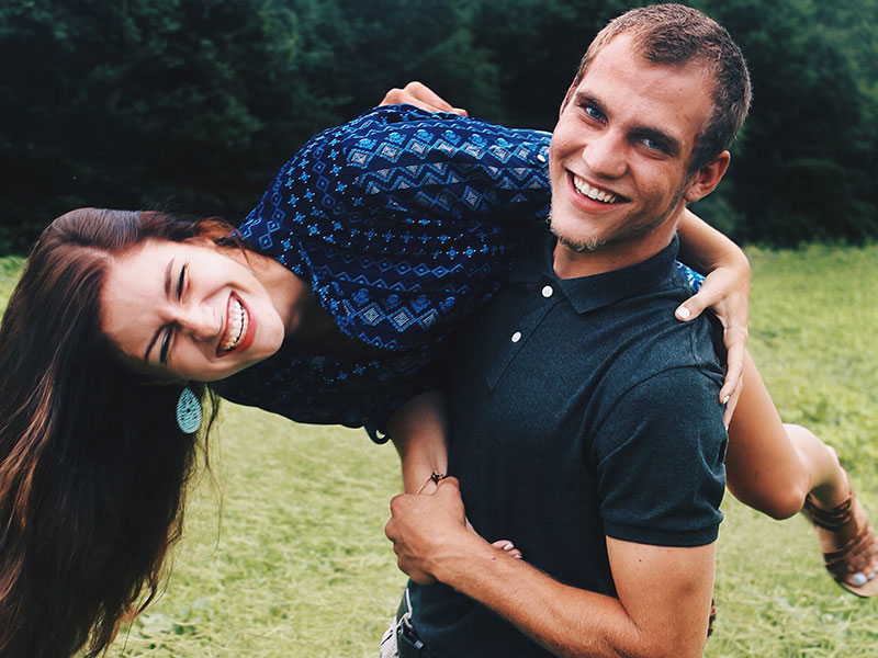 A girl who thought of cute boyfriend nicknames for her boyfriend laughing with him.