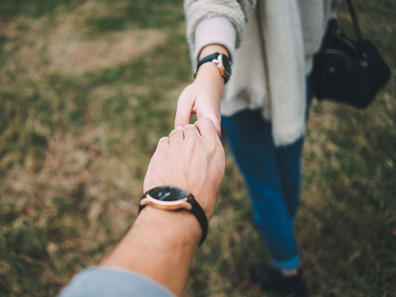 A couple dating in their 40s holding hands