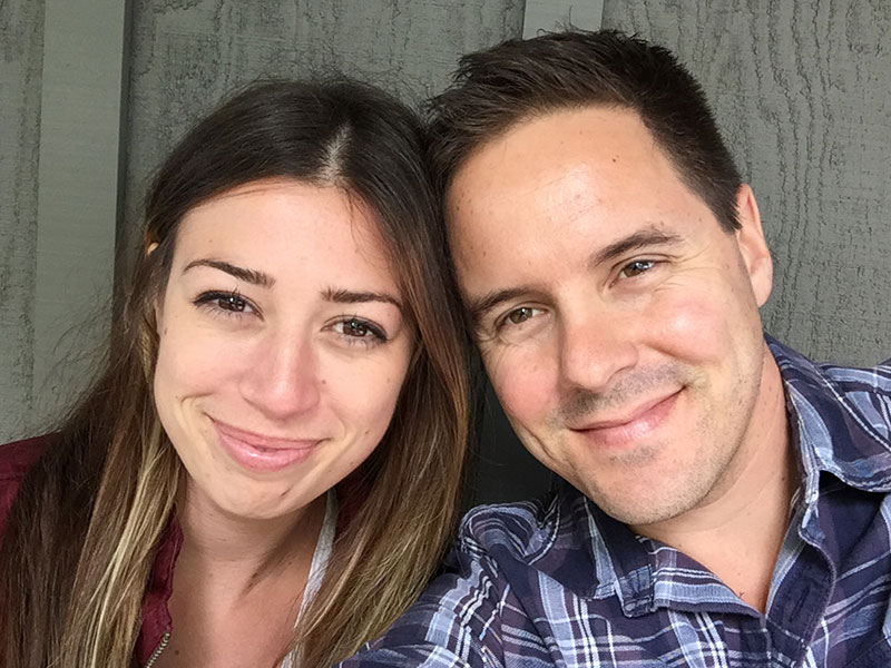 This woman who is 40 and single is smiling with a guy on a date.