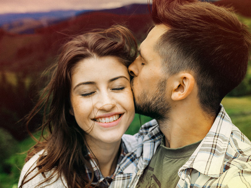 A couple kissing outside. They didn't know about some of these love facts but they affect how they date.