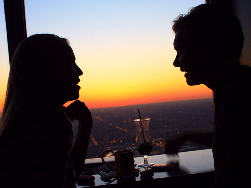 A man who took some dating advice that could sabotage him, talking to a woman over a table.