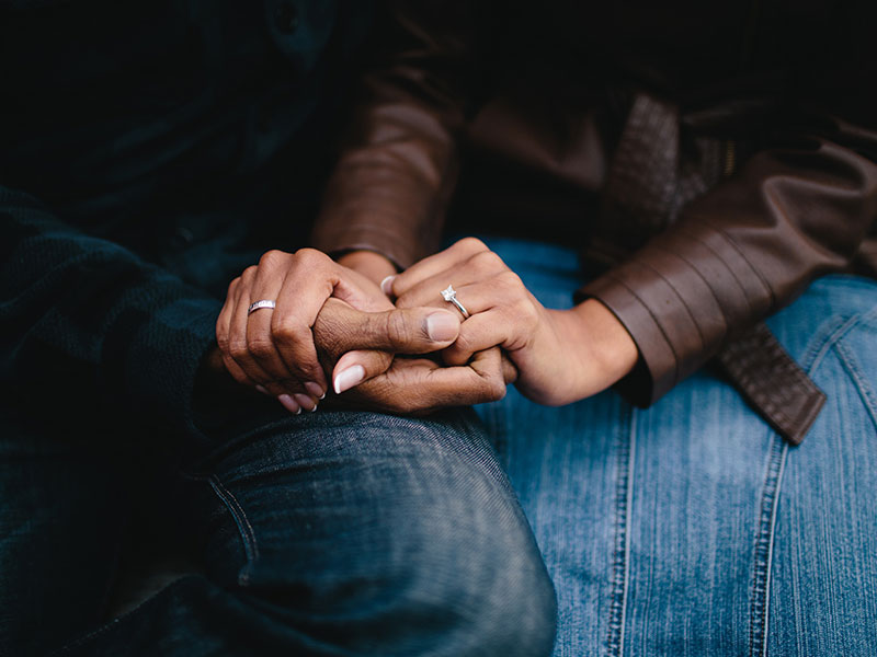 A woman who's going to break up with someone you care about, holding his hand in her lap.