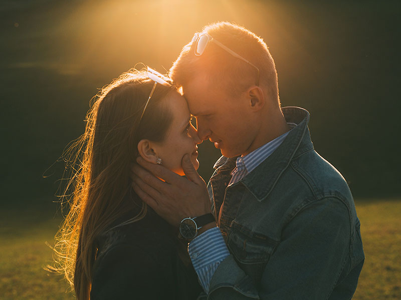 A couple who was looking for love kissing in the twilight.