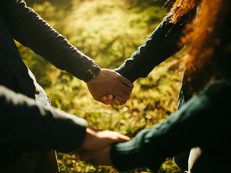 A couple holding hands after he said he loves me to the woman.