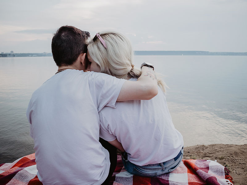A girl who wasn't sure she was getting back with an ex, cuddling in her exes arms happy with her choice after reading these questions.
