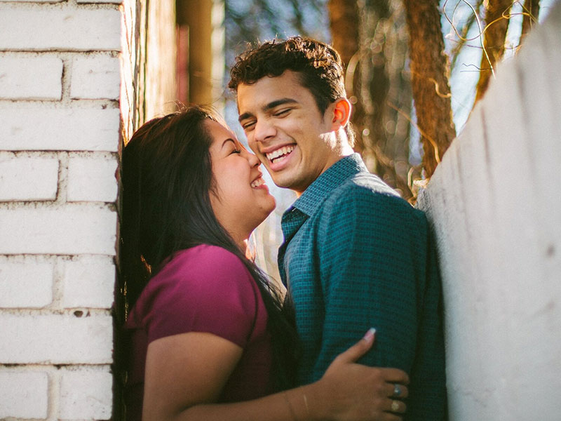 A couple laughing and smiling together because they listened to these conscious dating tips and now have a happy relationship.