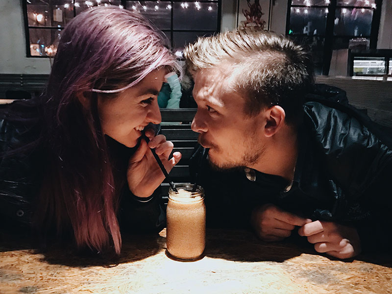 A couple who listened to these first date tips for non-drinkers sipping on some hot chocolate and smiling.