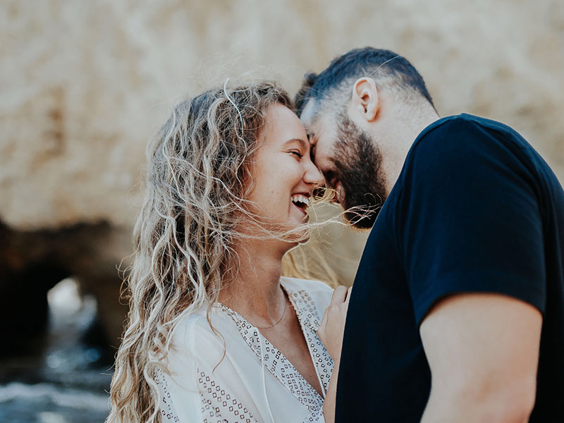 A woman who has a specific dating type, laughing with a guy on a date who's outside of her normal type.