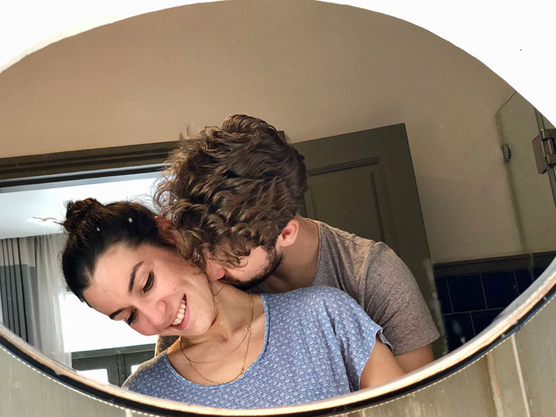 A couple who's always breaking up and getting back together kissing in front of a mirror.