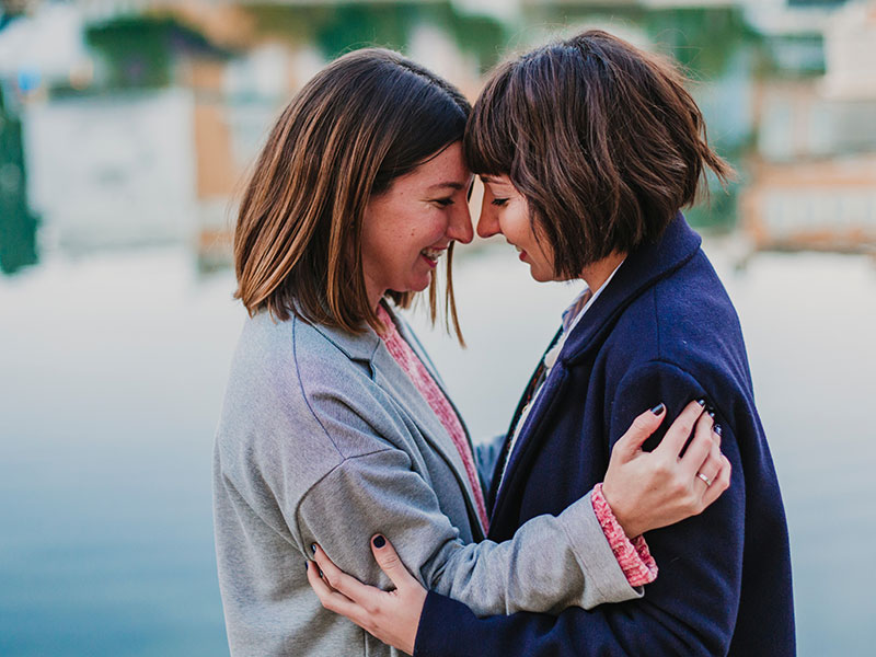 A couple looking into each other's eyes and smiling because they feel these signs of true love.
