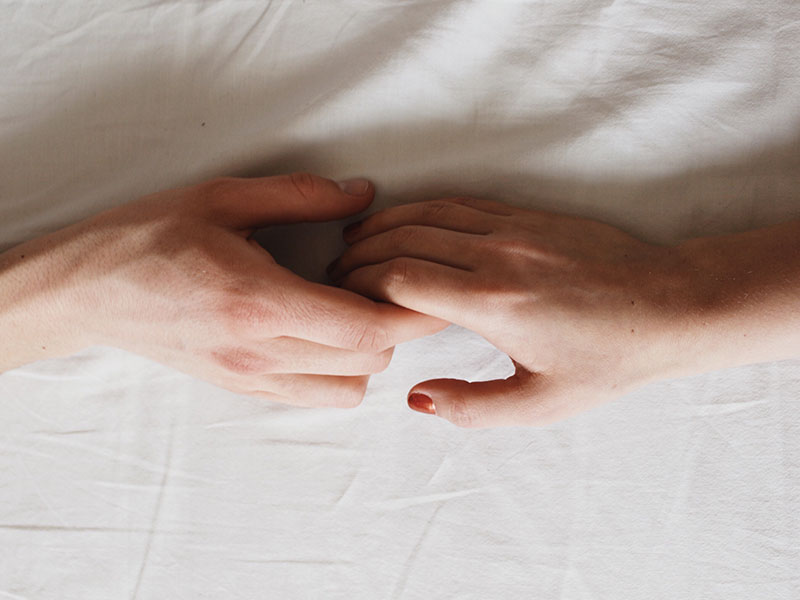 A woman learning how to leave someone you love, holding the hand of of the person they were breaking up with.