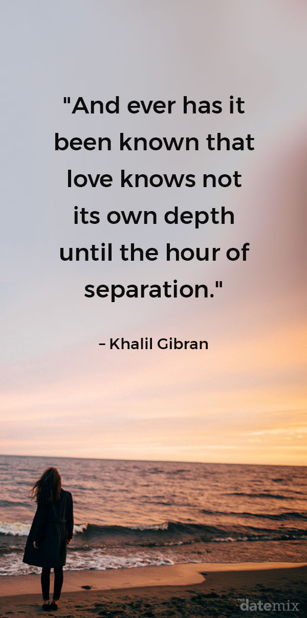 A woman on the beach looking at the sunset alone with the long distance love quote below written in the sky.